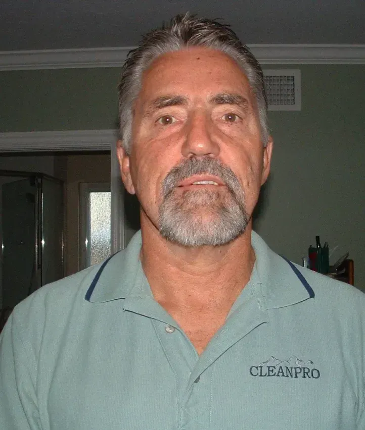 A man with a beard is wearing a cleanpro shirt