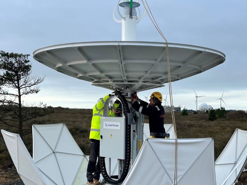 Engineers finalising installing a 3.9m  antenna for military SATCOM as part of a Dstl project at Goonhilly Earth Station