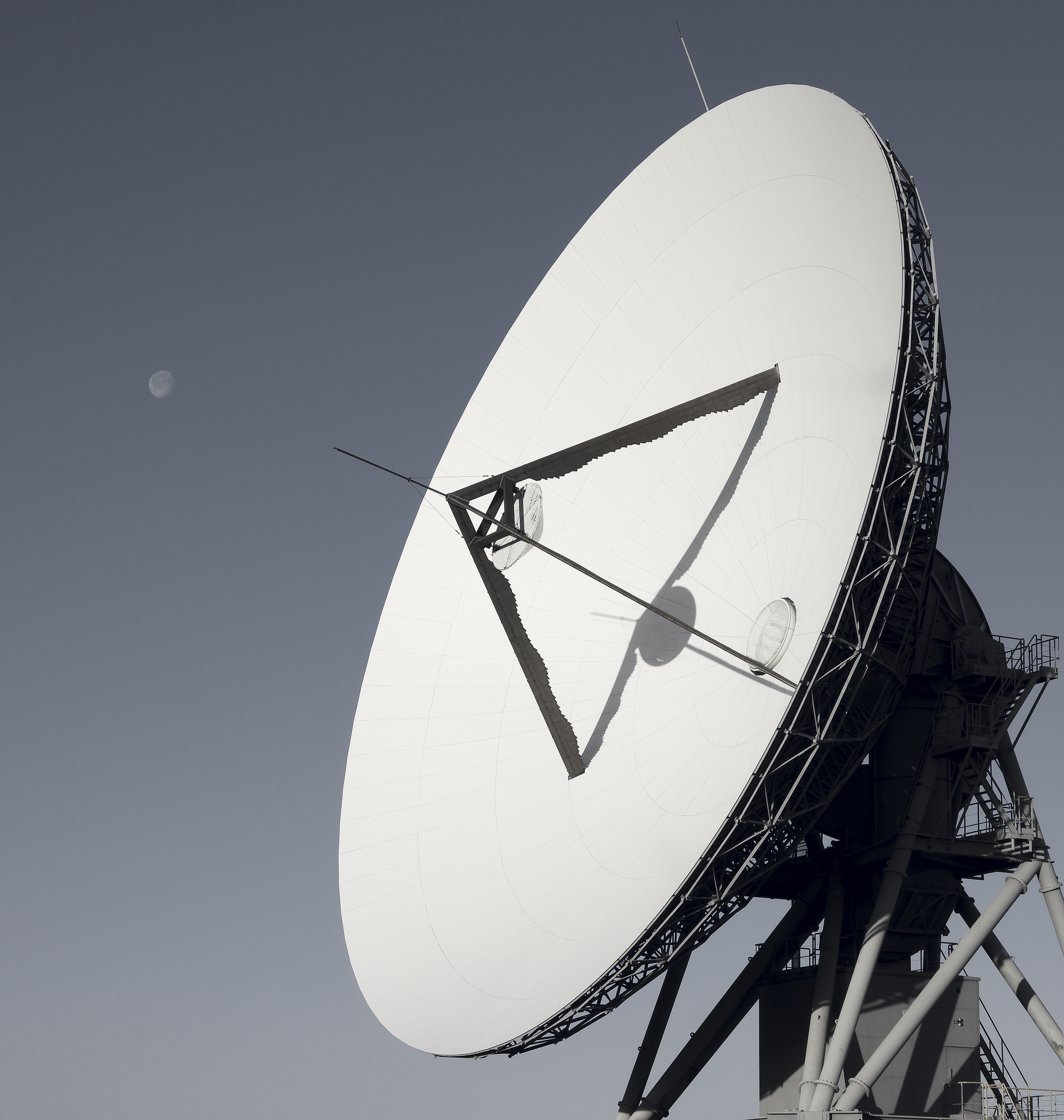 A picture of Goonhilly Earth Station Ltd's Deep Space Communications Antenna, GHY-6, and the Moon