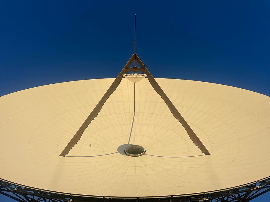 Photo showing Goonhilly's Ghy6 Deep Space antenna dish lite by sunlight