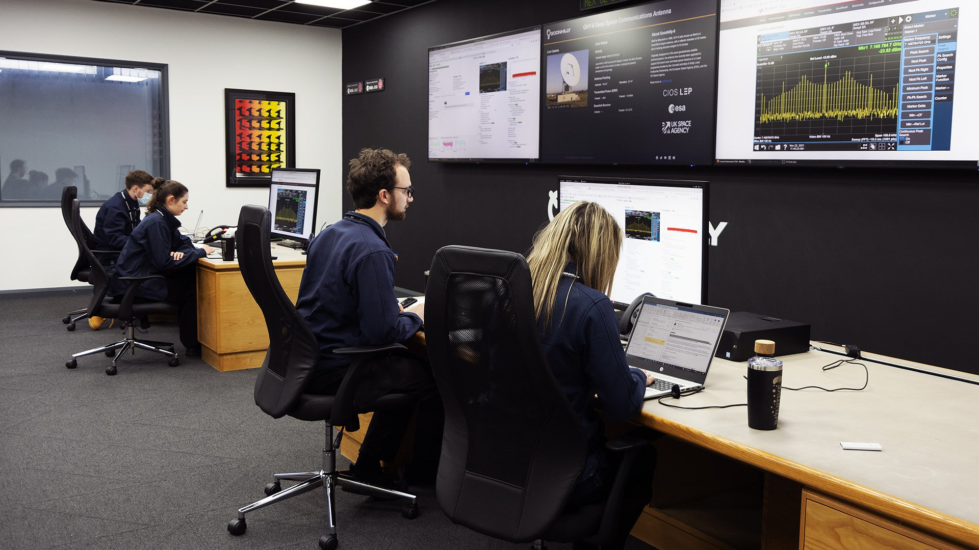 Young members of Goonhilly's Deep Space Network Operations team sit in the Operational Control Centre (OCA), tracking a spacecraft for an international space agency