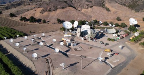 An aerial view of COMSAT Santa Paula, showing satellite antennas against Californian hills