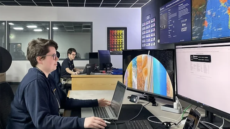 Young members of Goonhilly's Deep Space Network Operations team sit in the Operational Control Centre (OCA), tracking a spacecraft for an international space agency