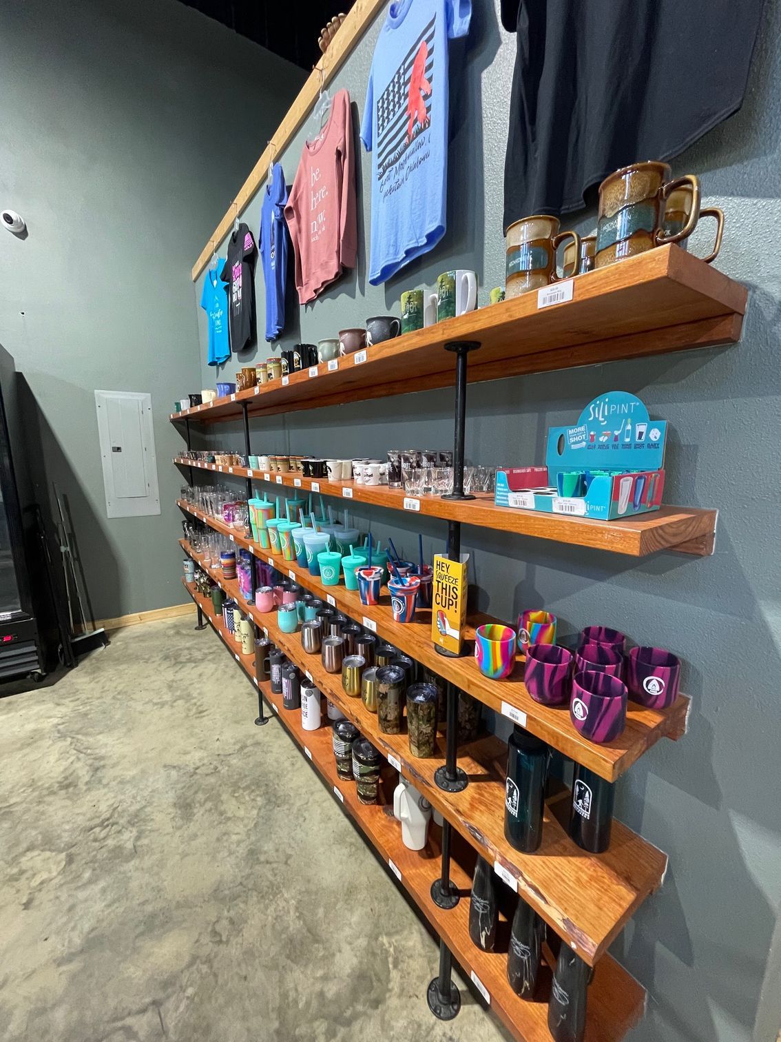 Wall shelves displaying colorful packaged merchandise in a retail store interior.