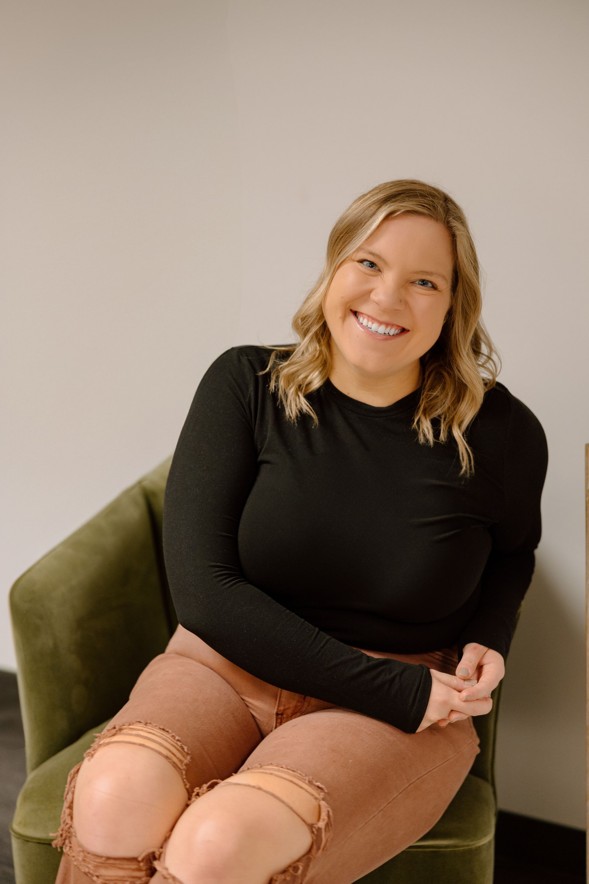 A woman in a striped sweater is smiling for the camera.