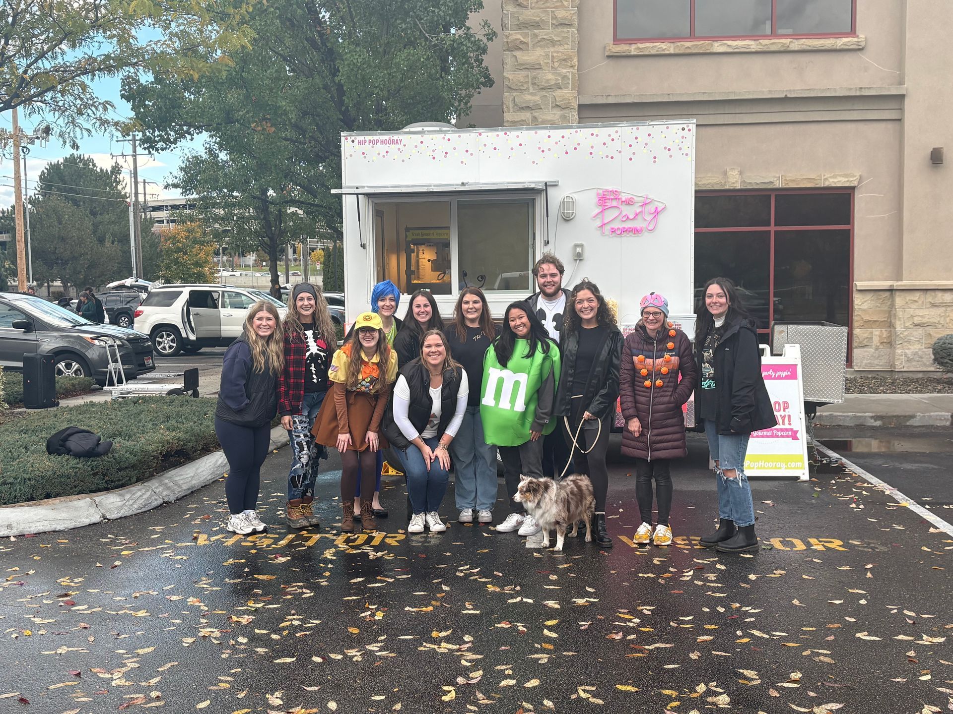 A group of women are posing for a picture with their dogs.