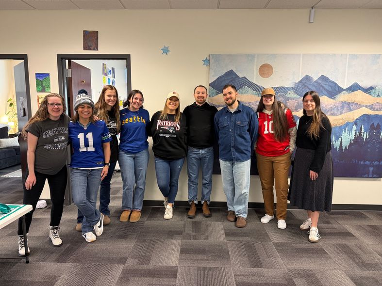 A group of people are sitting around a table in a conference room.