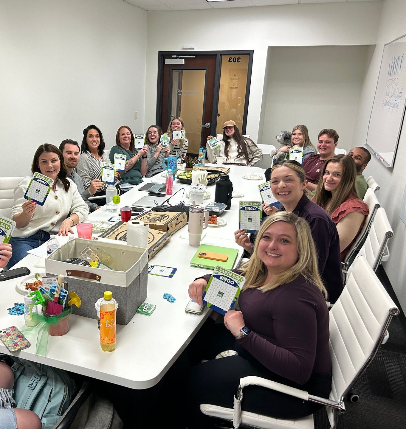 A group of people are sitting around a table in a conference room.
