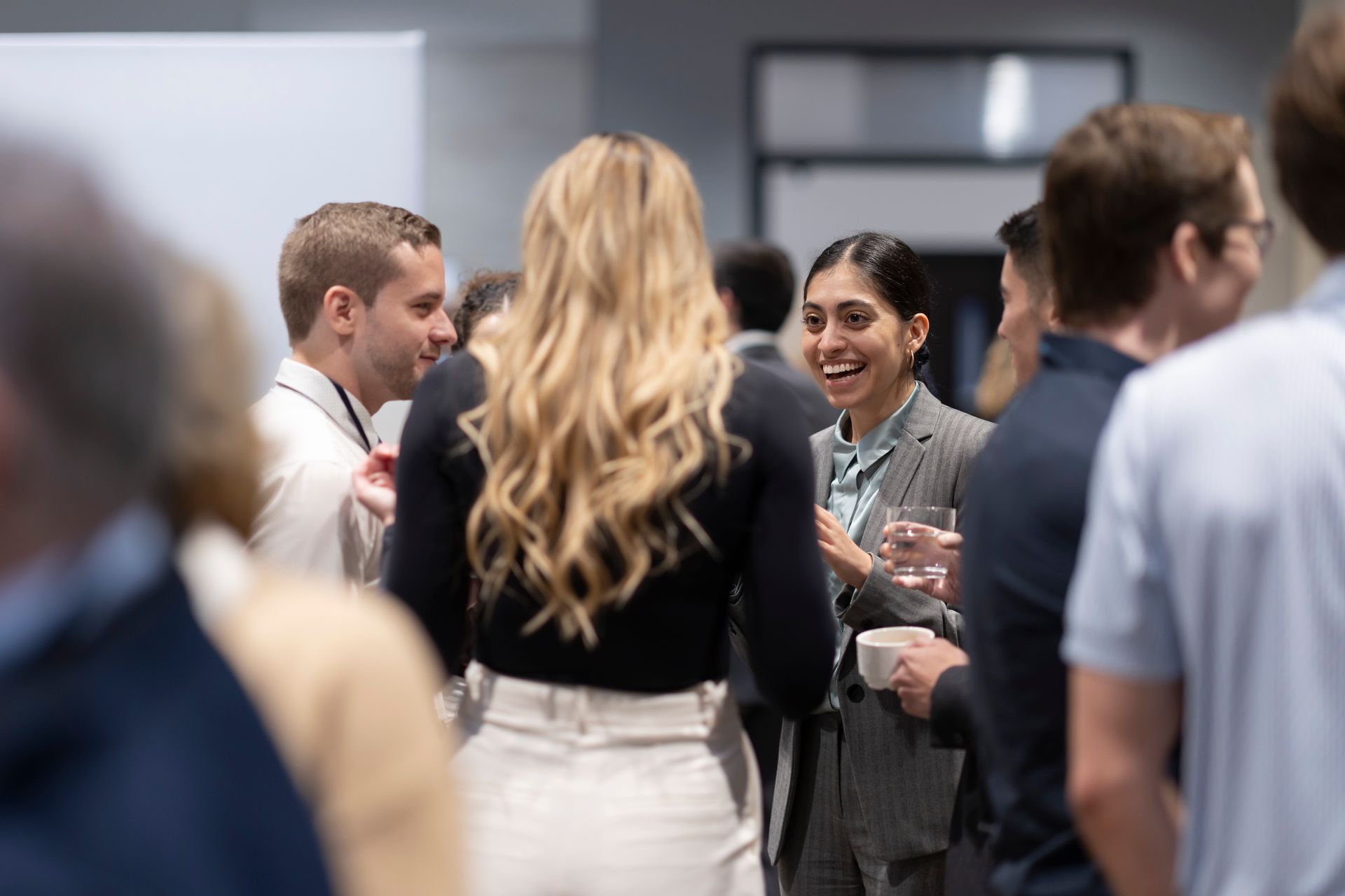 A group of doctors and nurses are having a meeting and looking at a clipboard.