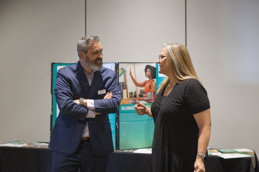 A man and a woman are talking to each other in a room.