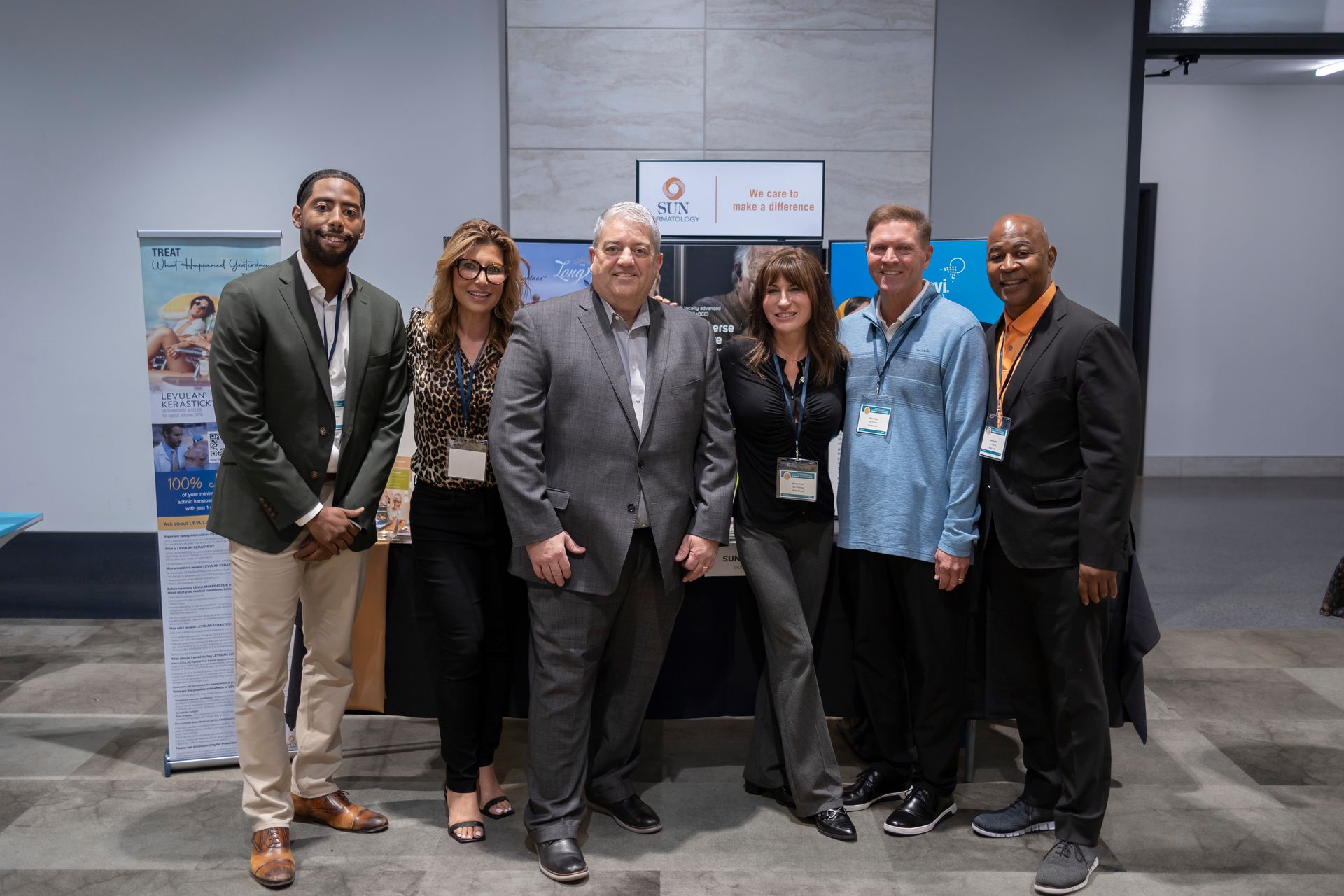 A group of people are posing for a picture in a room.