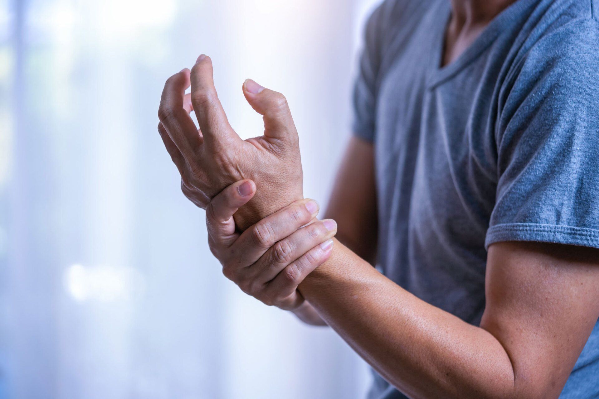 Man Suffering from a Wrist Pain — Portage, MI — Cornerstone Chiropractic Center