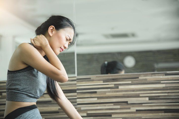 Woman Having Neck Pain After Workout — Portage, MI — Cornerstone Chiropractic Center