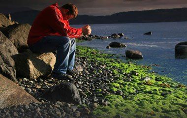 Man Sitting on the Rocks — Portage, MI — Cornerstone Chiropractic Center
