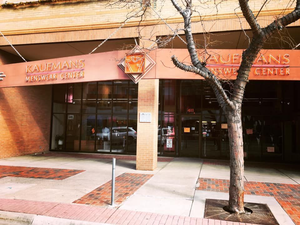 Entrance to the Kauffman Center for Performing Arts with a brick facade and a tree.