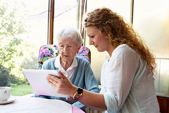 Caregiver showing support to patient at the table