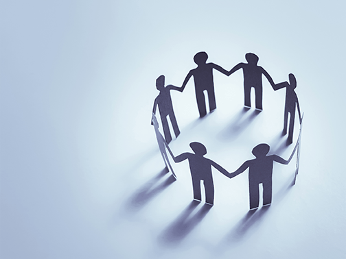 Team members in a circle holding hands