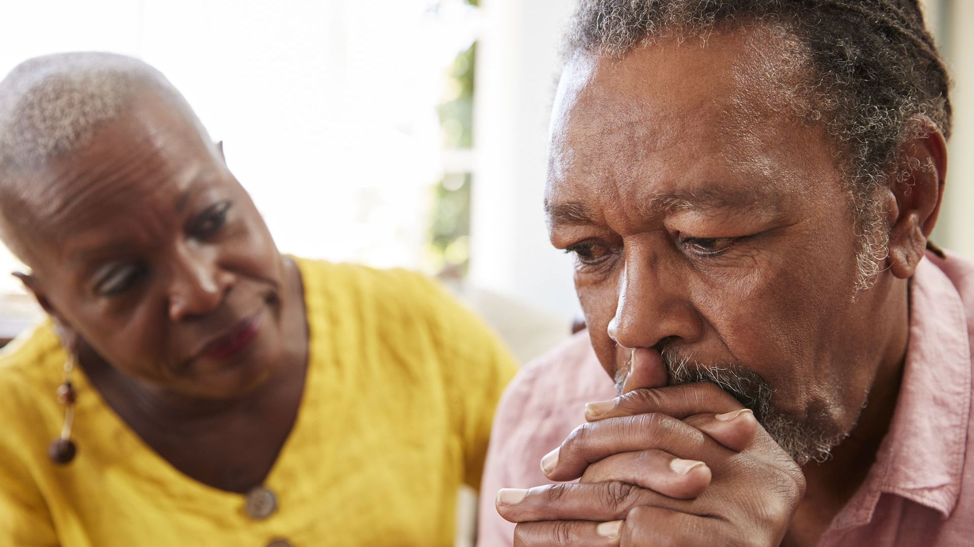 Husband and wife discussing grief.