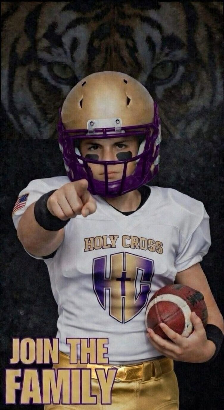 Football player in maroon jersey holding ball, smiling, surrounded by teammates on a field.