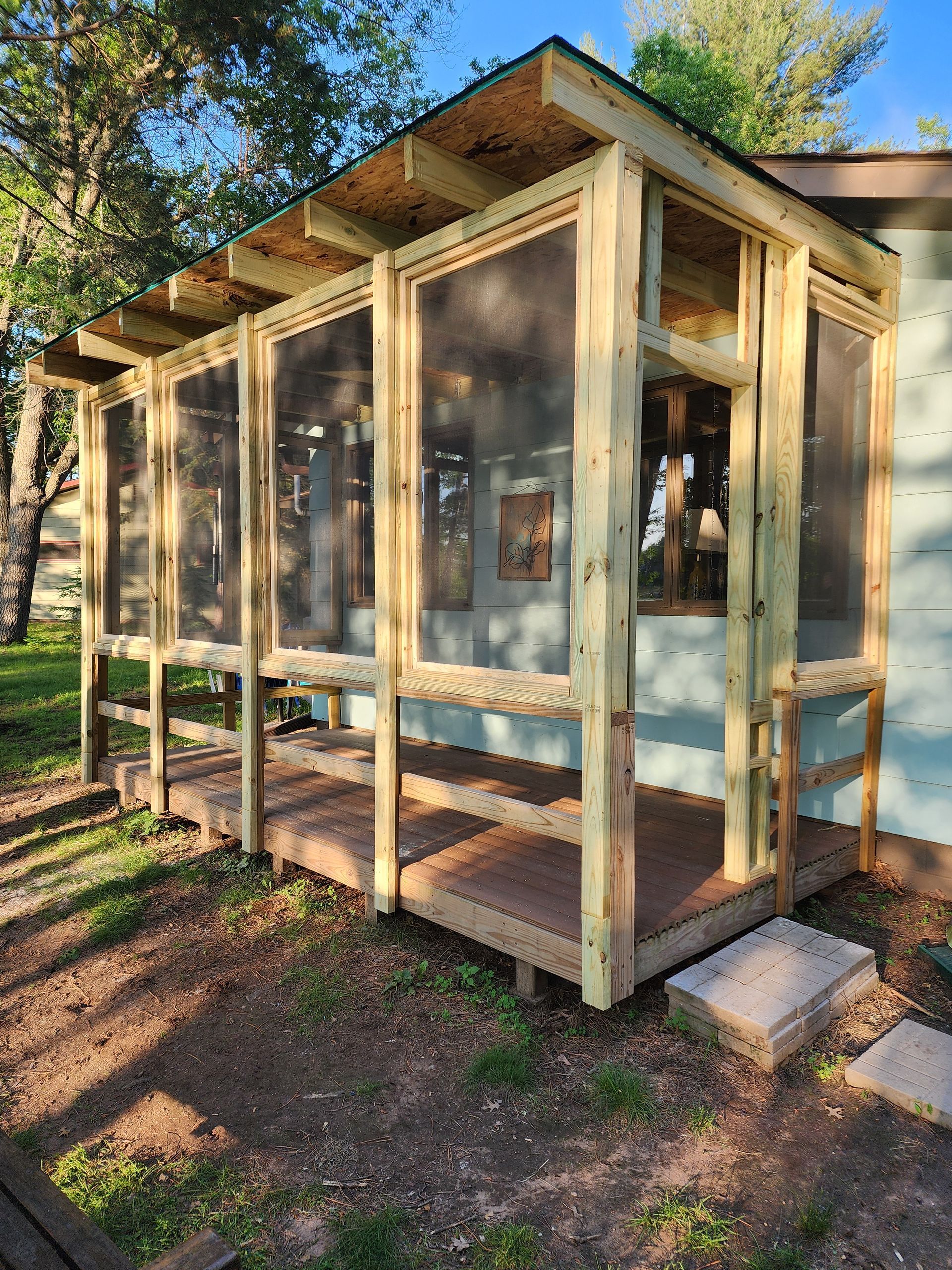Person in denim shirt with tool belt writing on clipboard. Person in denim shirt with tool belt writing on clipboard.