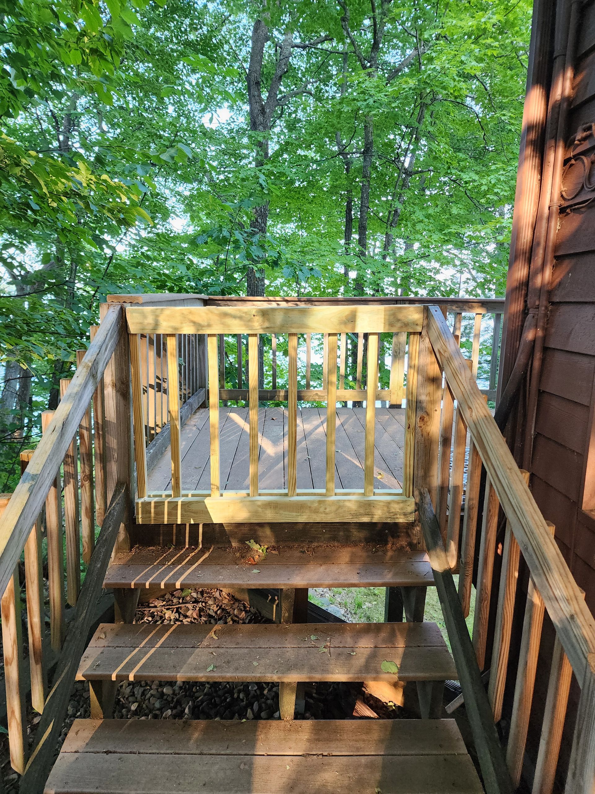 Two people shaking hands; one in work clothes, the other in an orange shirt.