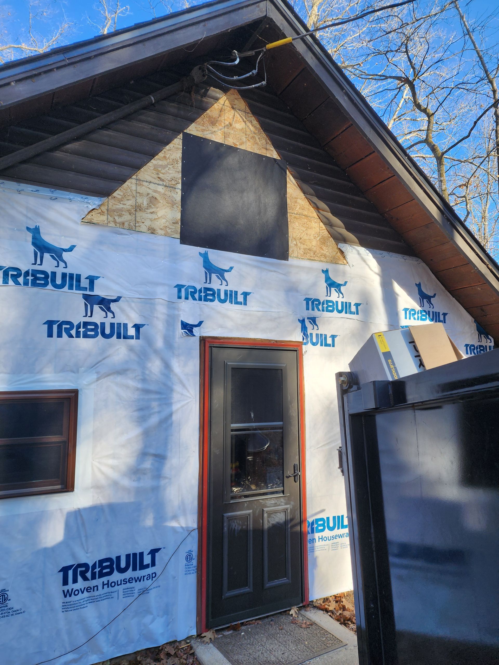 Person using a power drill to install drawer hardware inside a kitchen cabinet.
