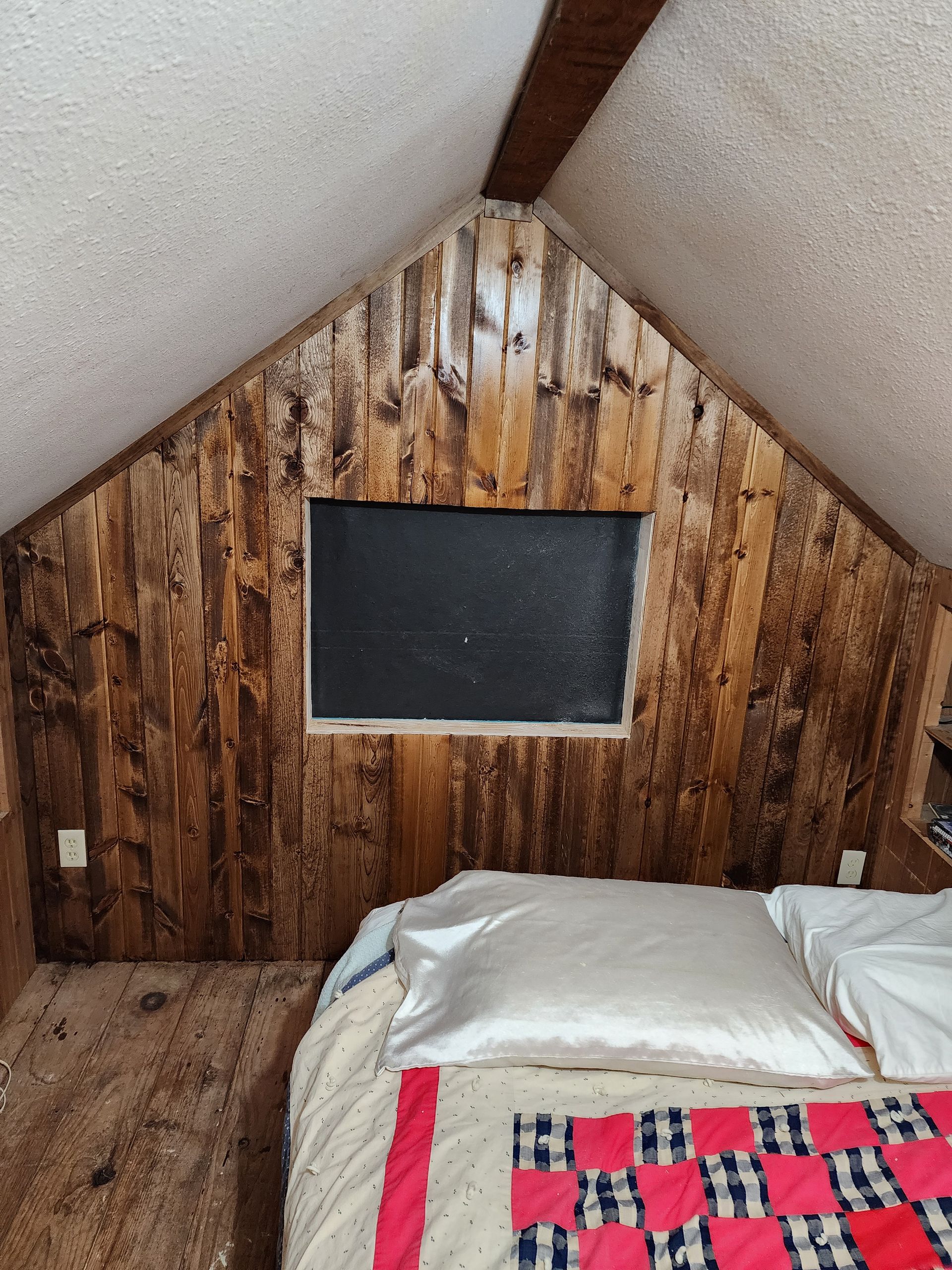 A worker measures the underside of a cabinet with a tape measure.