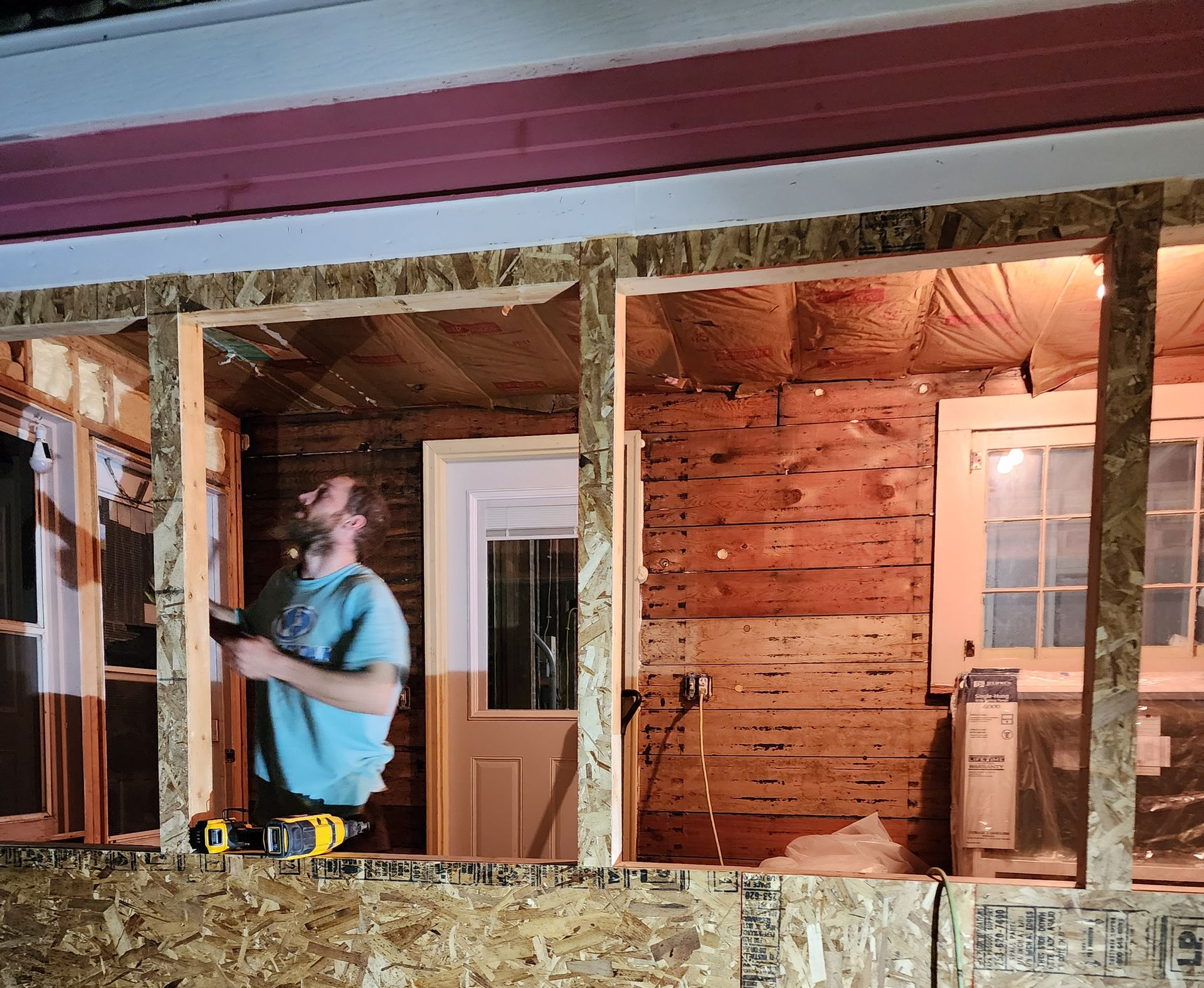 Person with tool belt, holding a tool, likely working outdoors. Tools include screwdrivers, pliers, and a tape measure. Person with tool belt, holding a tool, likely working outdoors. Tools include screwdrivers, pliers, and a tape measure.