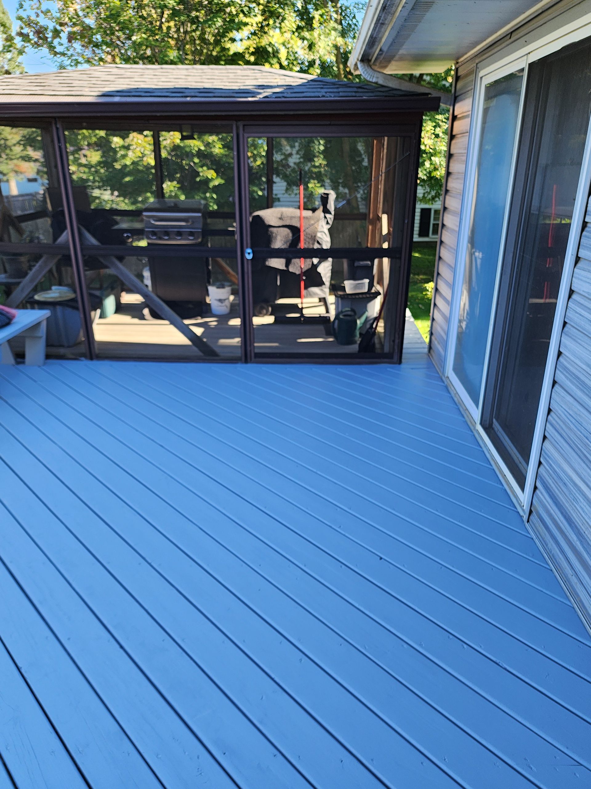 Hands in work gloves adjusting a door latch on a wooden door. Hands in work gloves adjusting a door latch on a wooden door.