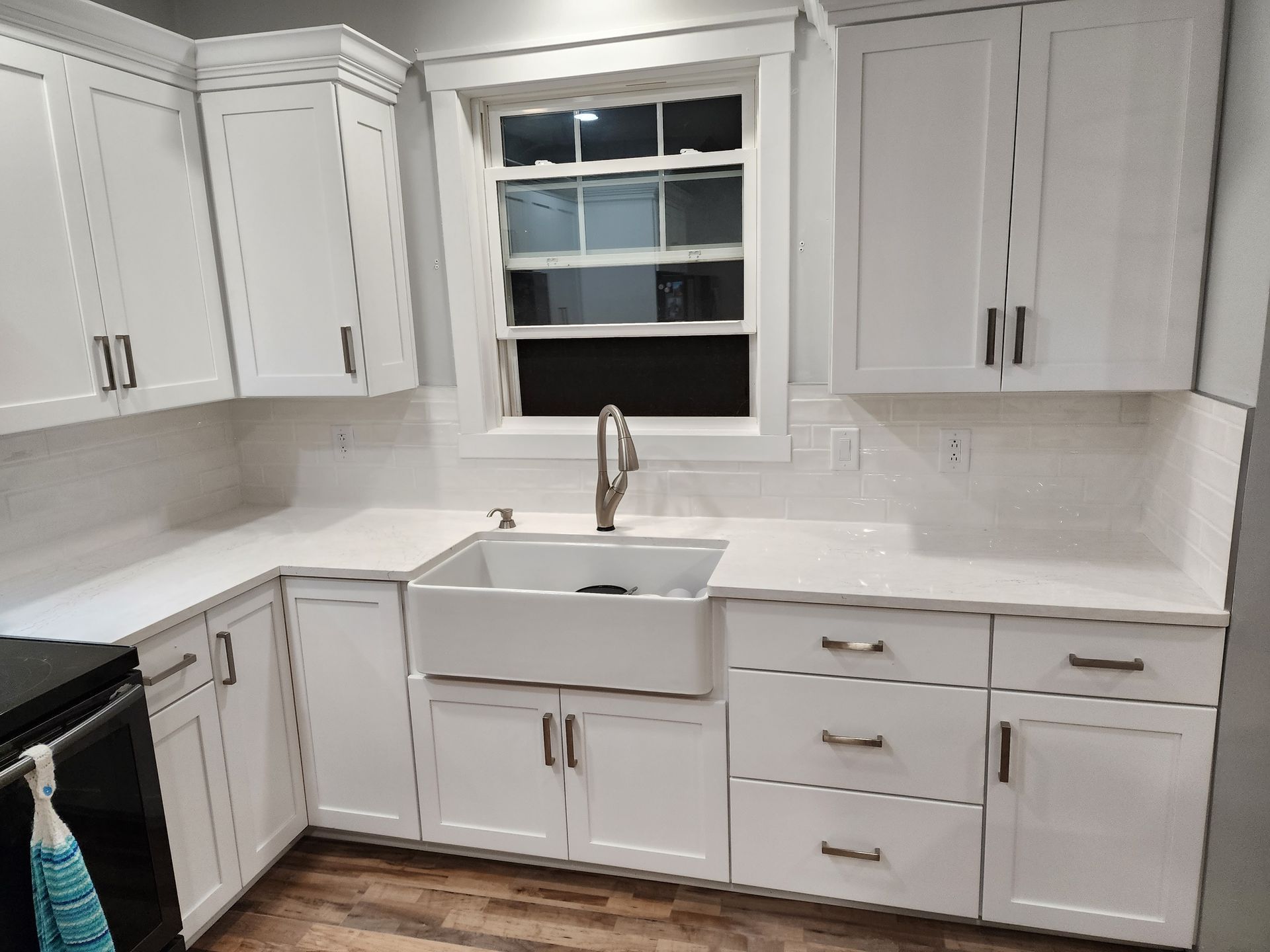 Carpenter using a yellow power drill to screw a board into a wooden frame, wearing a tool belt. Carpenter using a yellow power drill to screw a board into a wooden frame, wearing a tool belt.