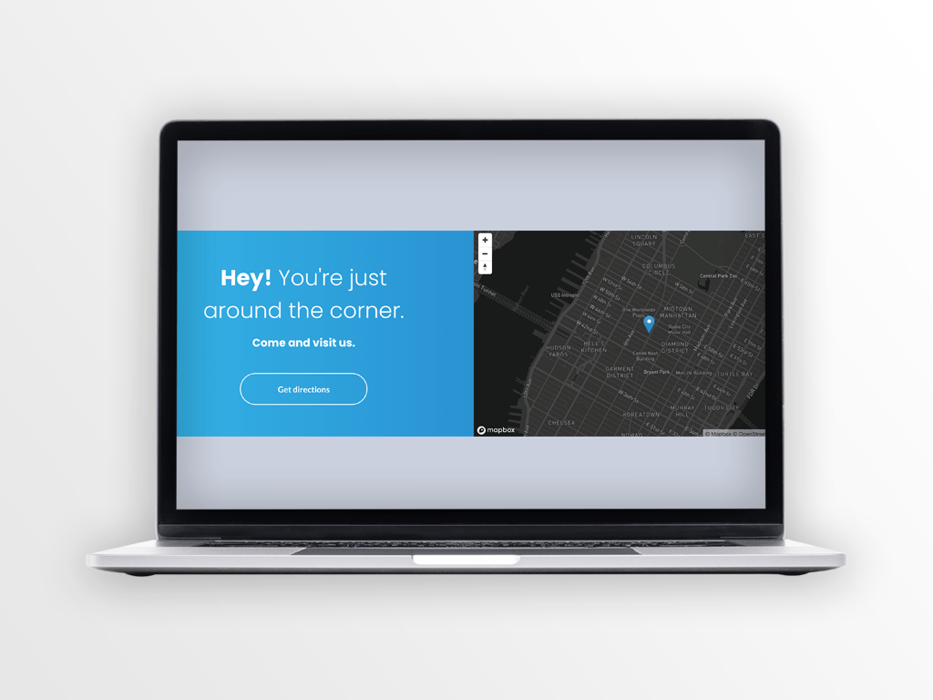 Laptop displaying a website with a blue banner and a map.