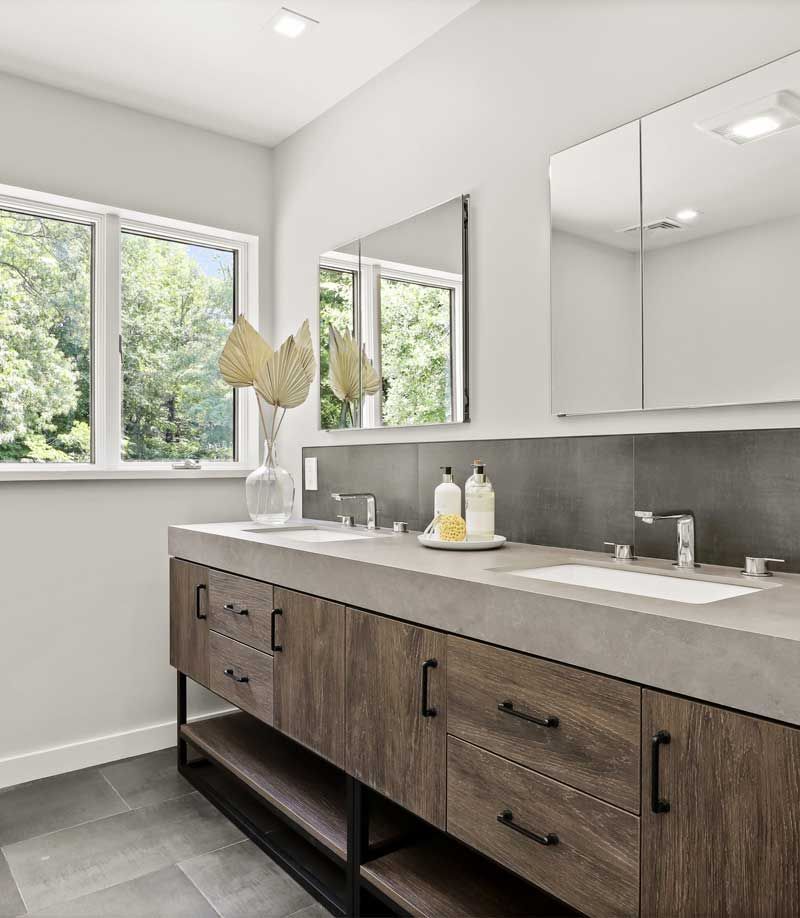 A bathroom with two sinks , a mirror and a window — Westchester, NY — Precision Tile, Marble & Stonework