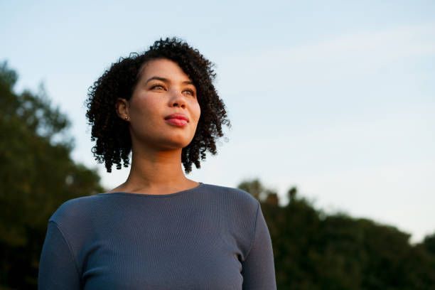 A person receiving acupuncture on their back; needles inserted by a healthcare provider.