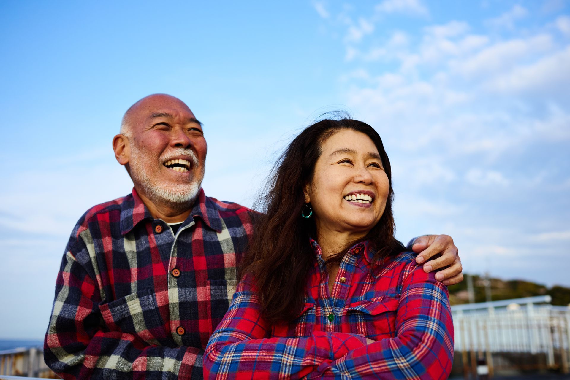 Hands inserting acupuncture needles into a person's back.
