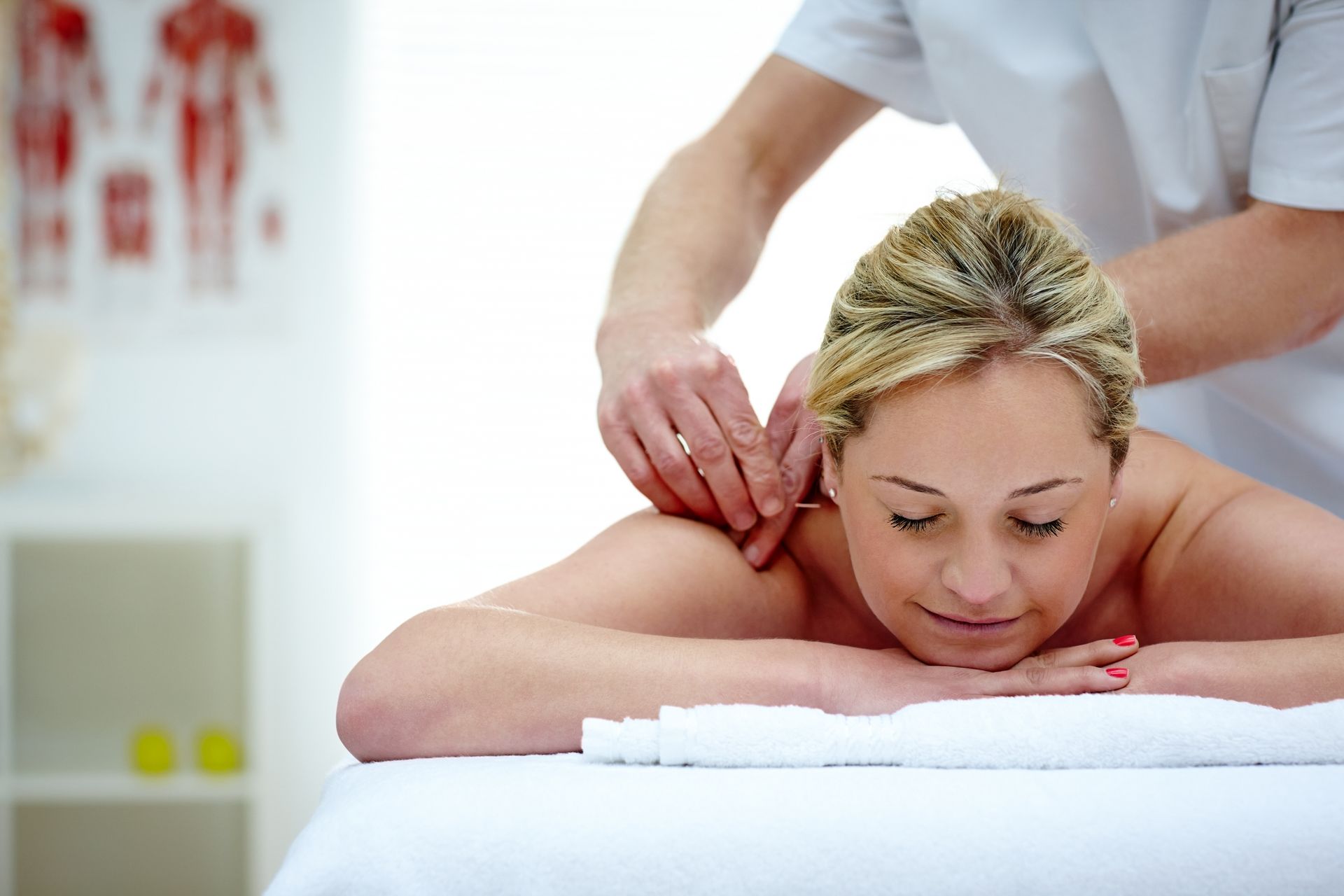 Acupuncture needles arranged in a wooden bowl; setting includes dried herbs.