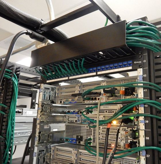 A server rack with a bunch of wires coming out of it