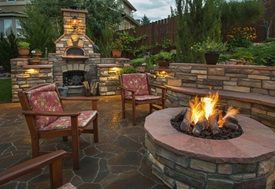 There is a fire pit in the middle of the patio.