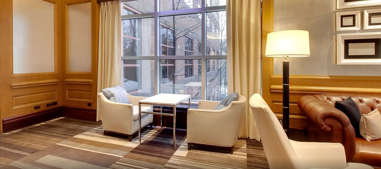 A living room filled with furniture and a large window.