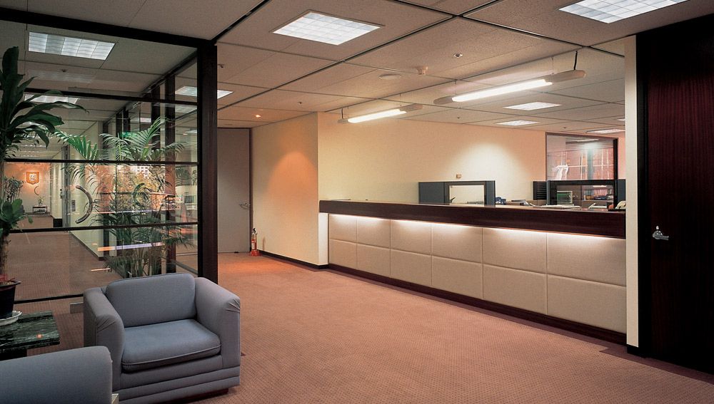 A waiting room with two chairs and a counter