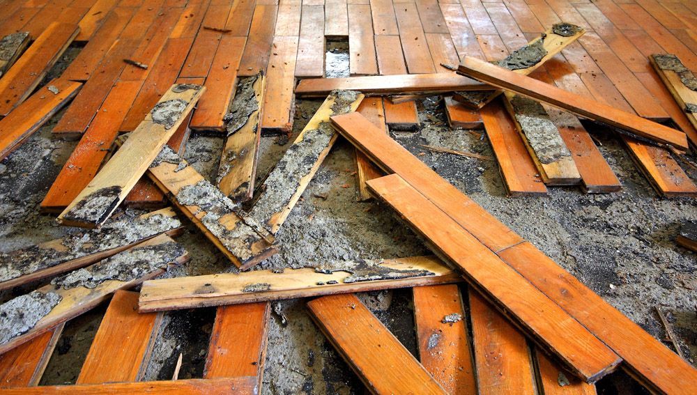 A bunch of wooden boards are laying on the floor