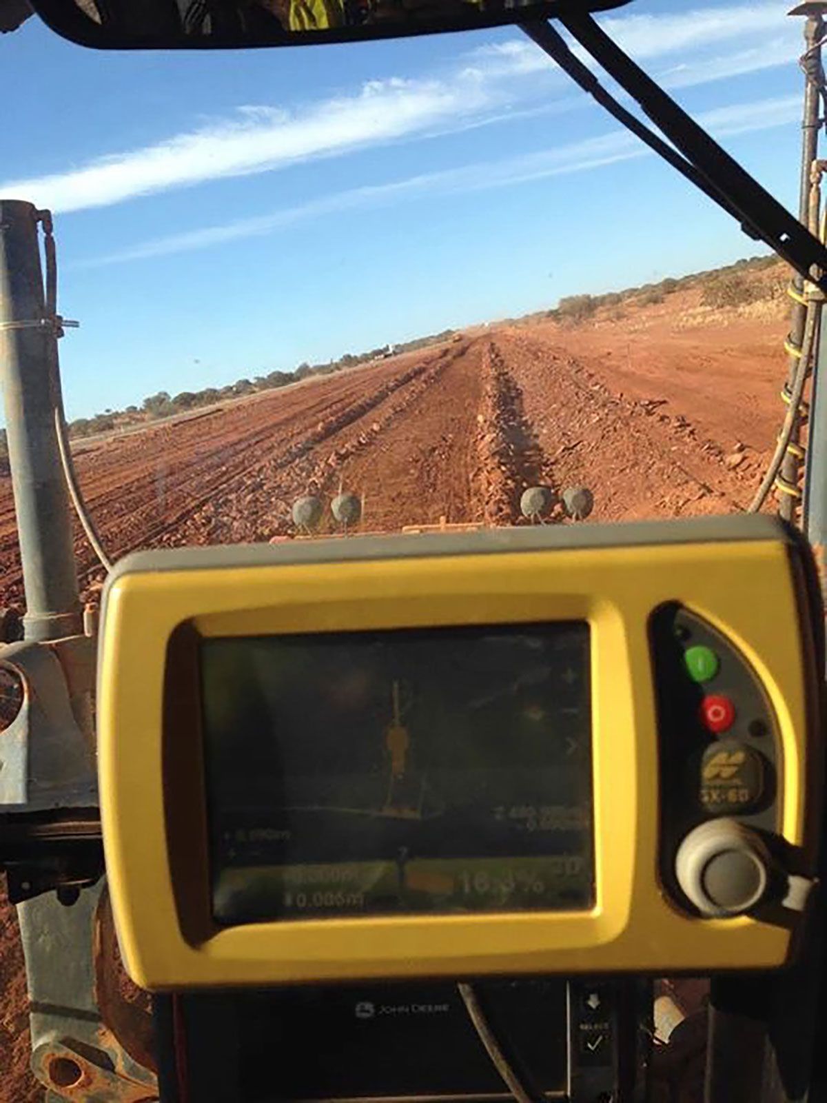A grader equipped with a yellow GPS system