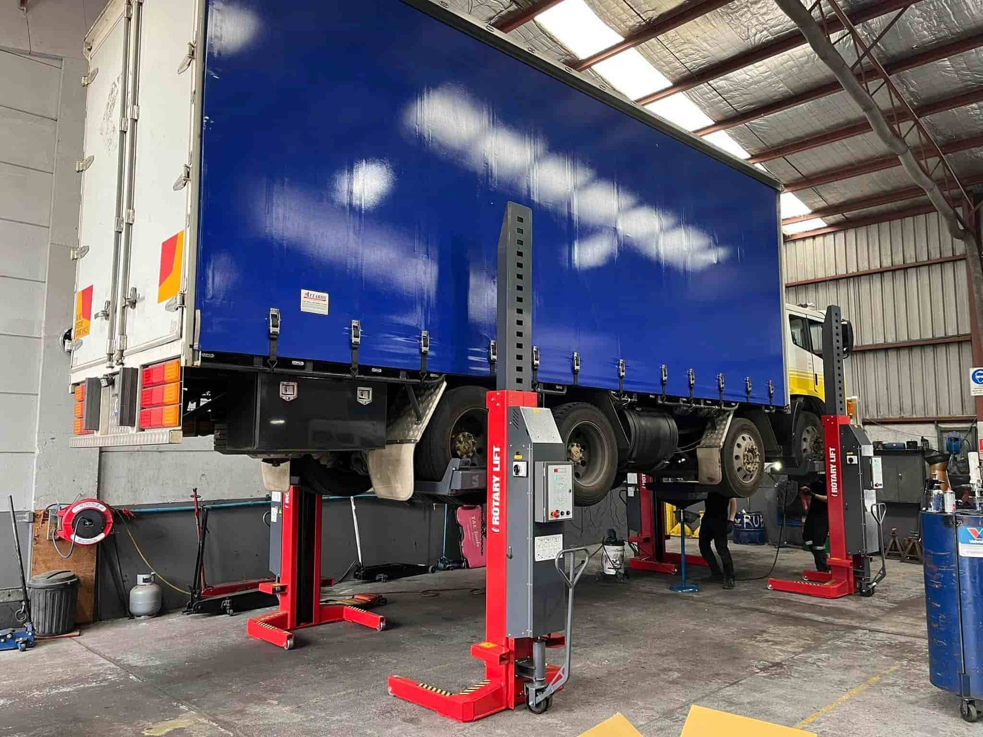 A Blue Truck Is Sitting on A Lift in A Garage — Coast Mechanical Services In Gosford, NSW