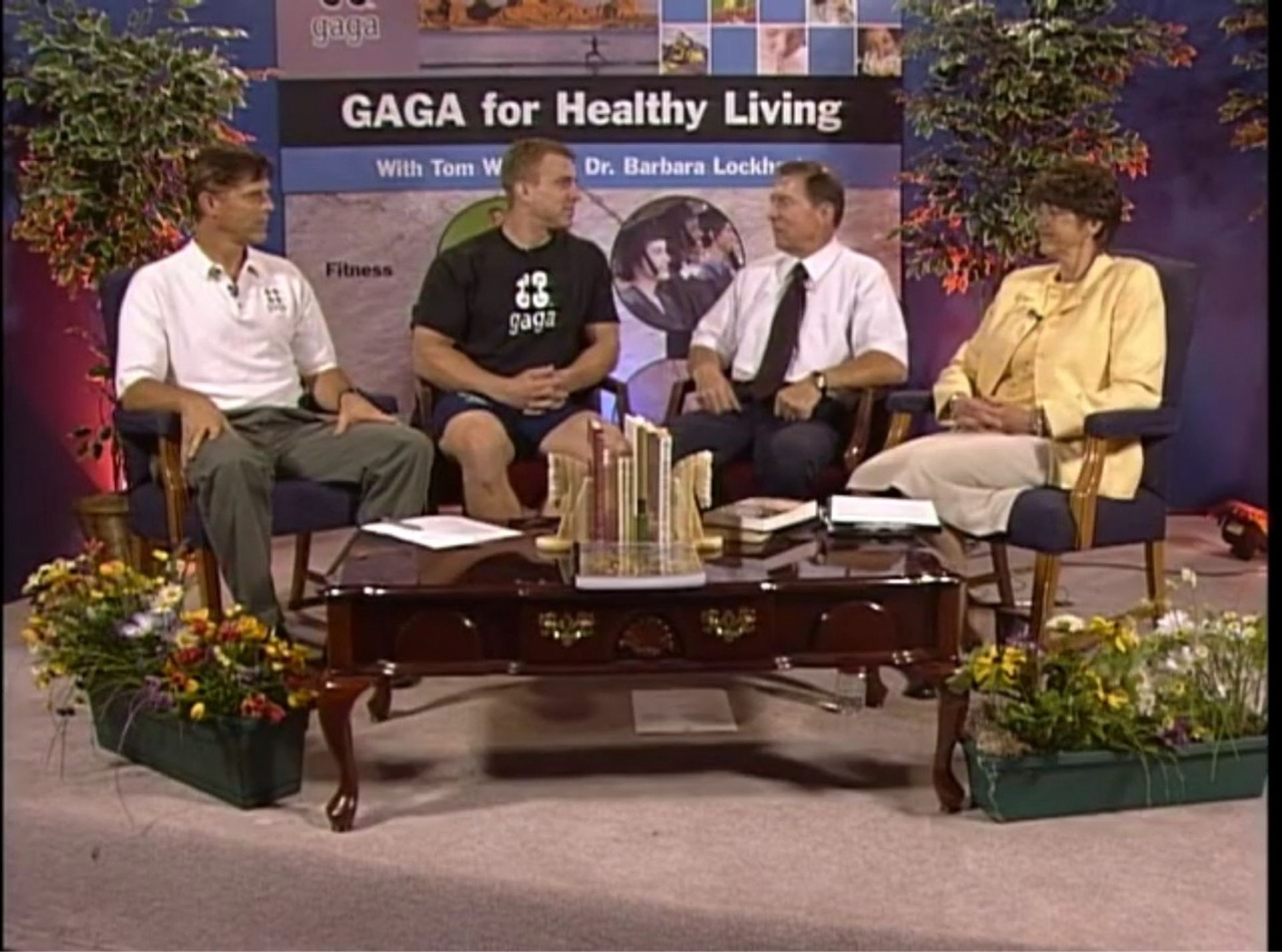 A group of people are sitting in front of a sign that says gaga for healthy living