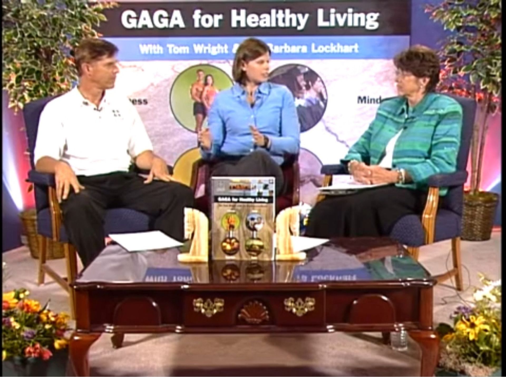 Three people are sitting in front of a sign that says gaga for healthy living
