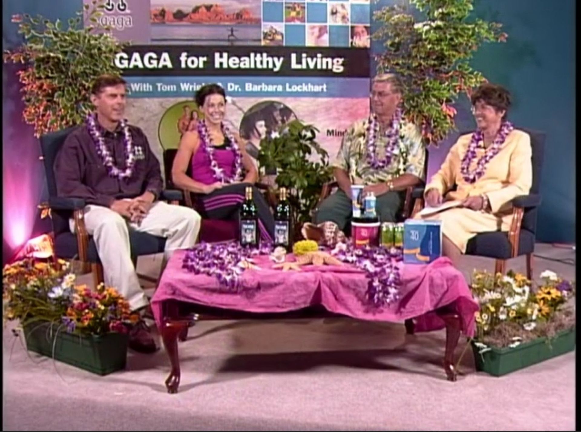 A group of people are sitting in front of a sign that says gaga for healthy living