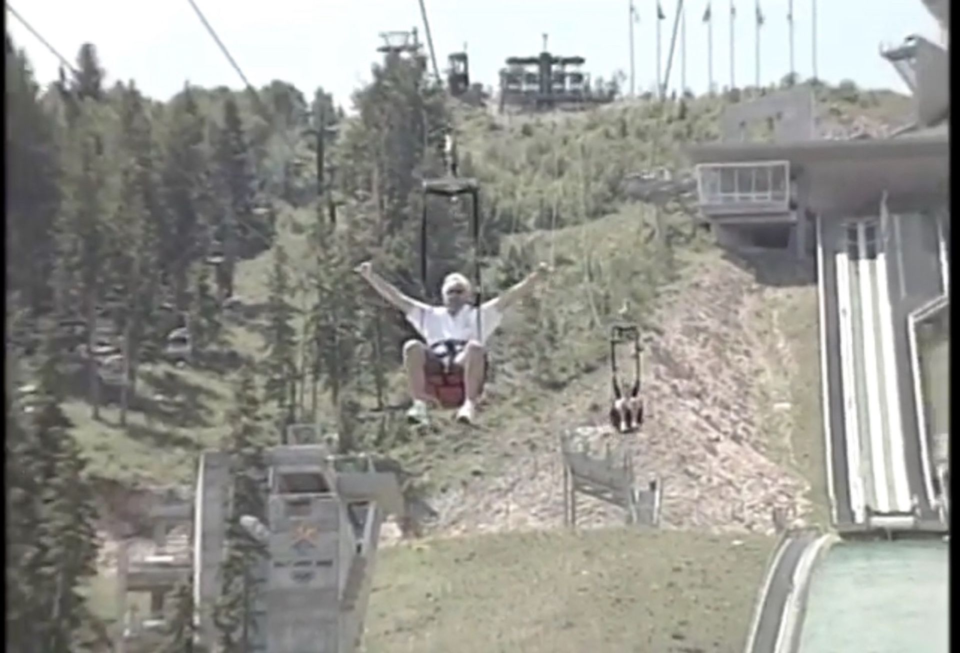 Tom Wright is riding a ski lift up a hill.