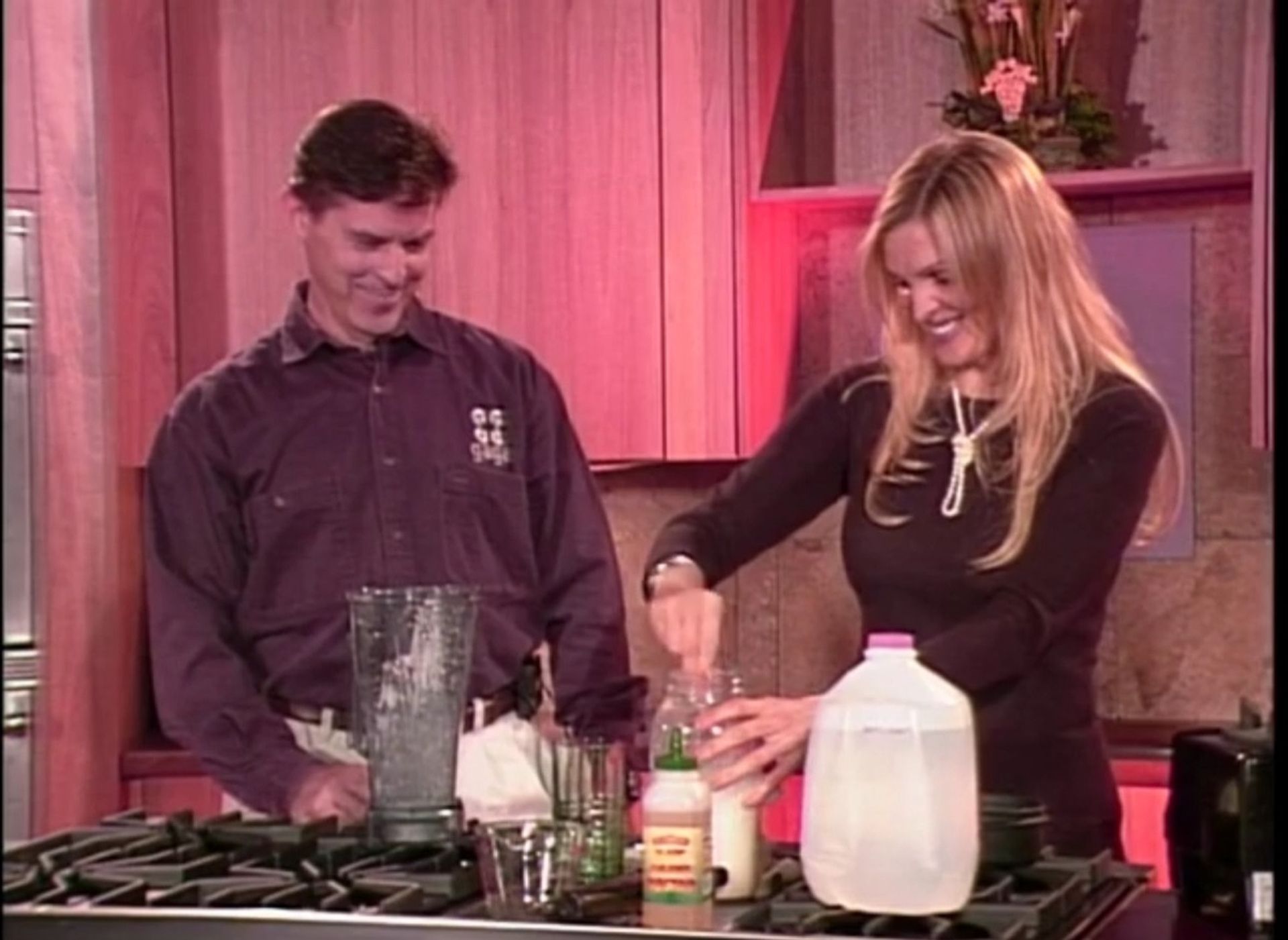 Tom Wright and a woman are preparing food in a kitchen.