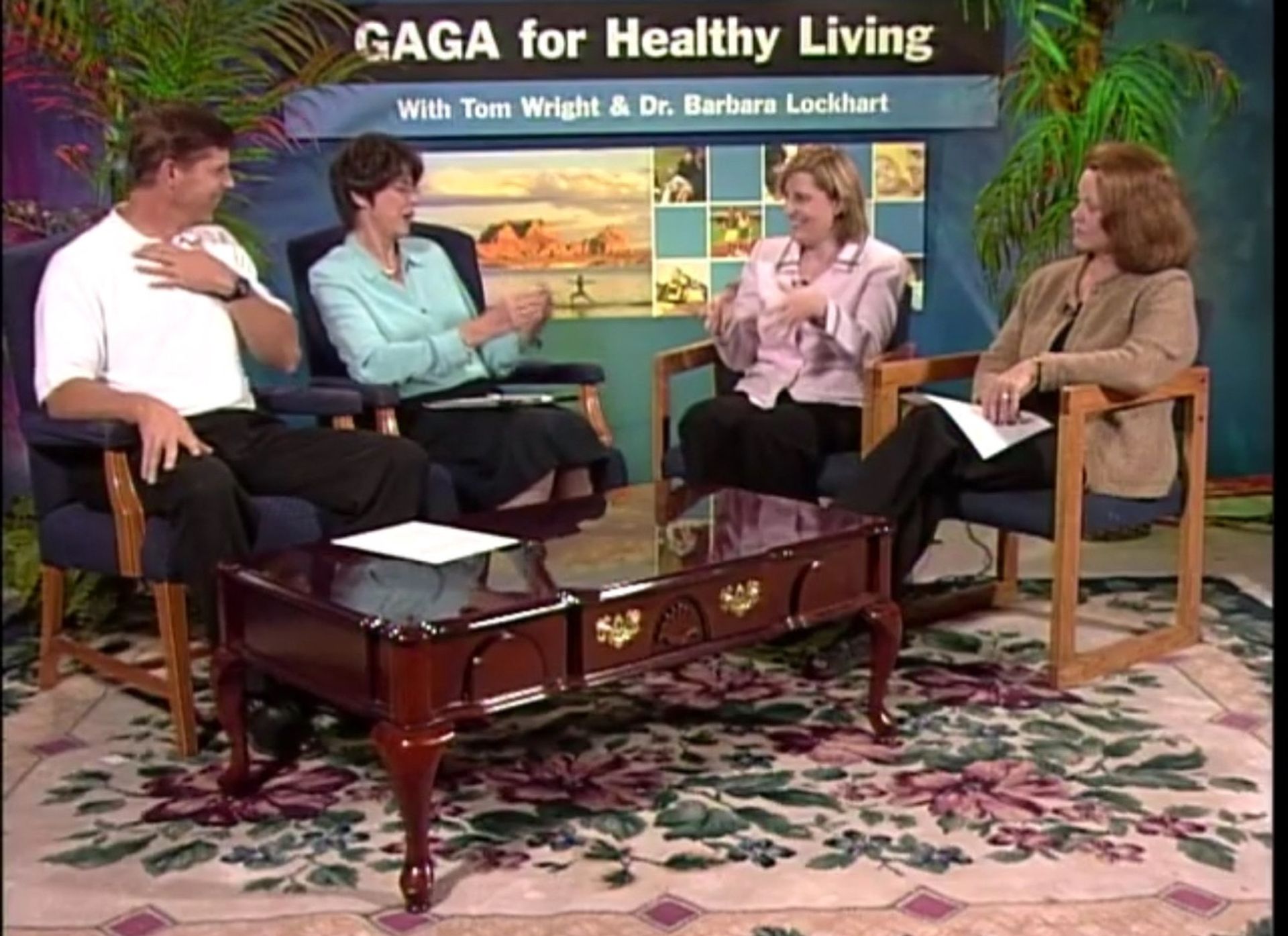 A group of people sitting around a table with gaga for healthy living written above them