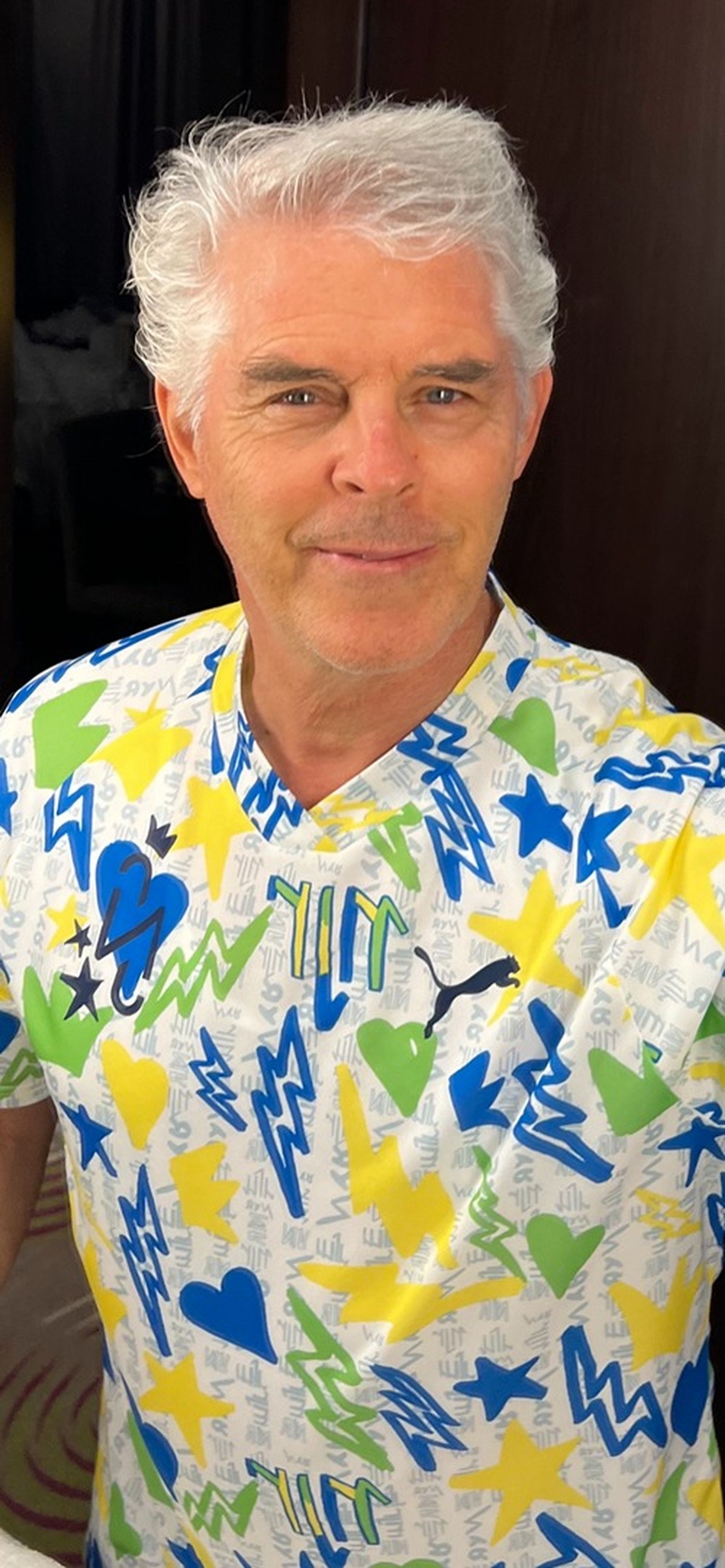 Tom Wright is wearing a colorful shirt.