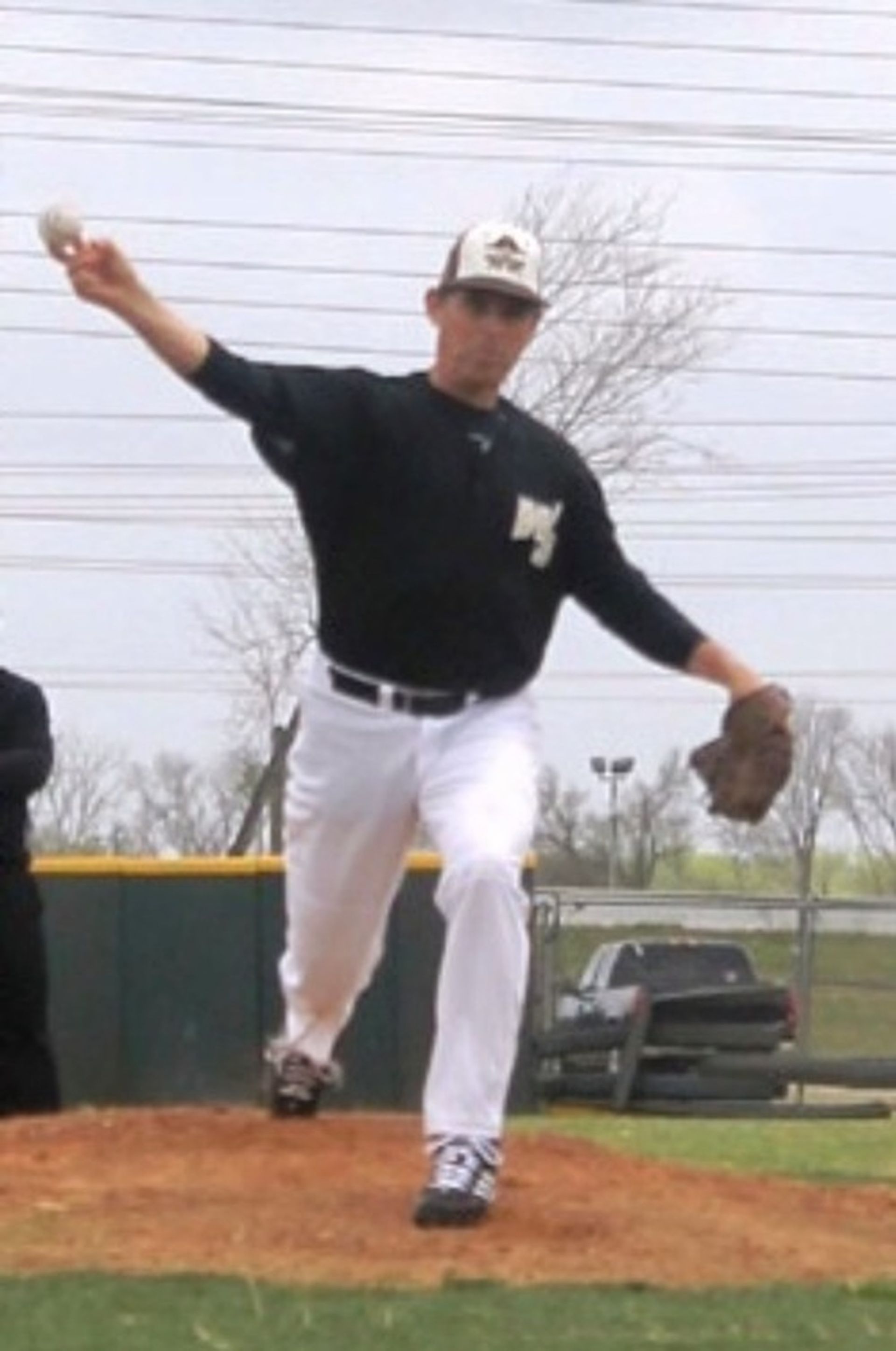 Tom Wright wearing a black shirt with the letter m on it